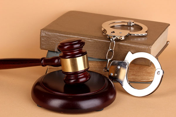 Gavel handcuffs and book on law